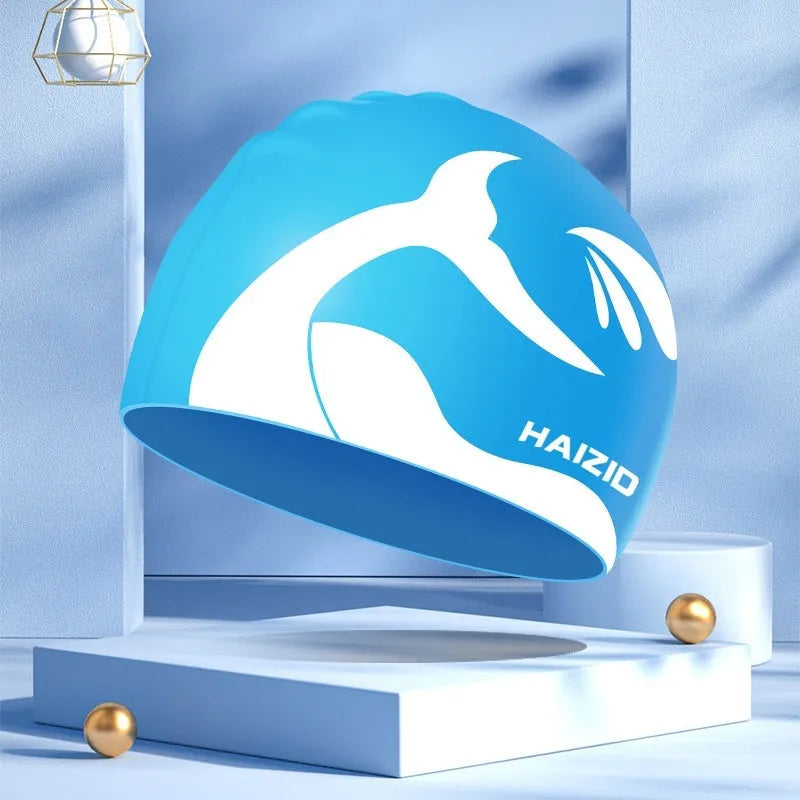 Silicone swimming cap with whale tail pattern and integrated ear protectors in grey.