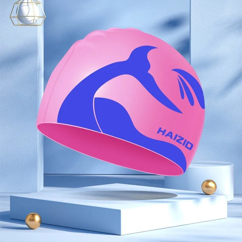 Silicone swimming cap with whale tail pattern and integrated ear protectors in grey.