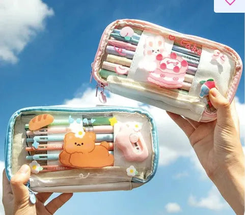 Transparent pen case with Japanese girl and heart graphic in pink or red colour options.