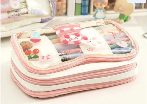 Transparent pen case with Japanese girl and heart graphic in pink or red colour options.