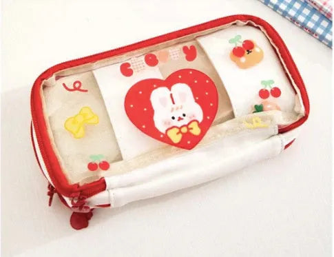 Transparent pen case with Japanese girl and heart graphic in pink or red colour options.