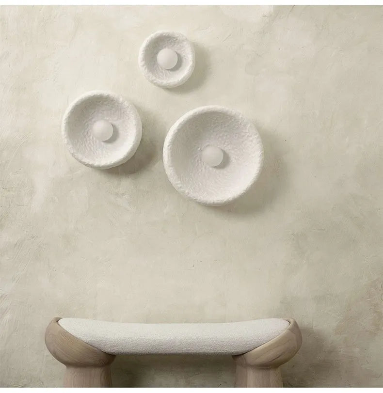 Japanese-style modern simple wall lamp with a round resin shade in warm white light.
