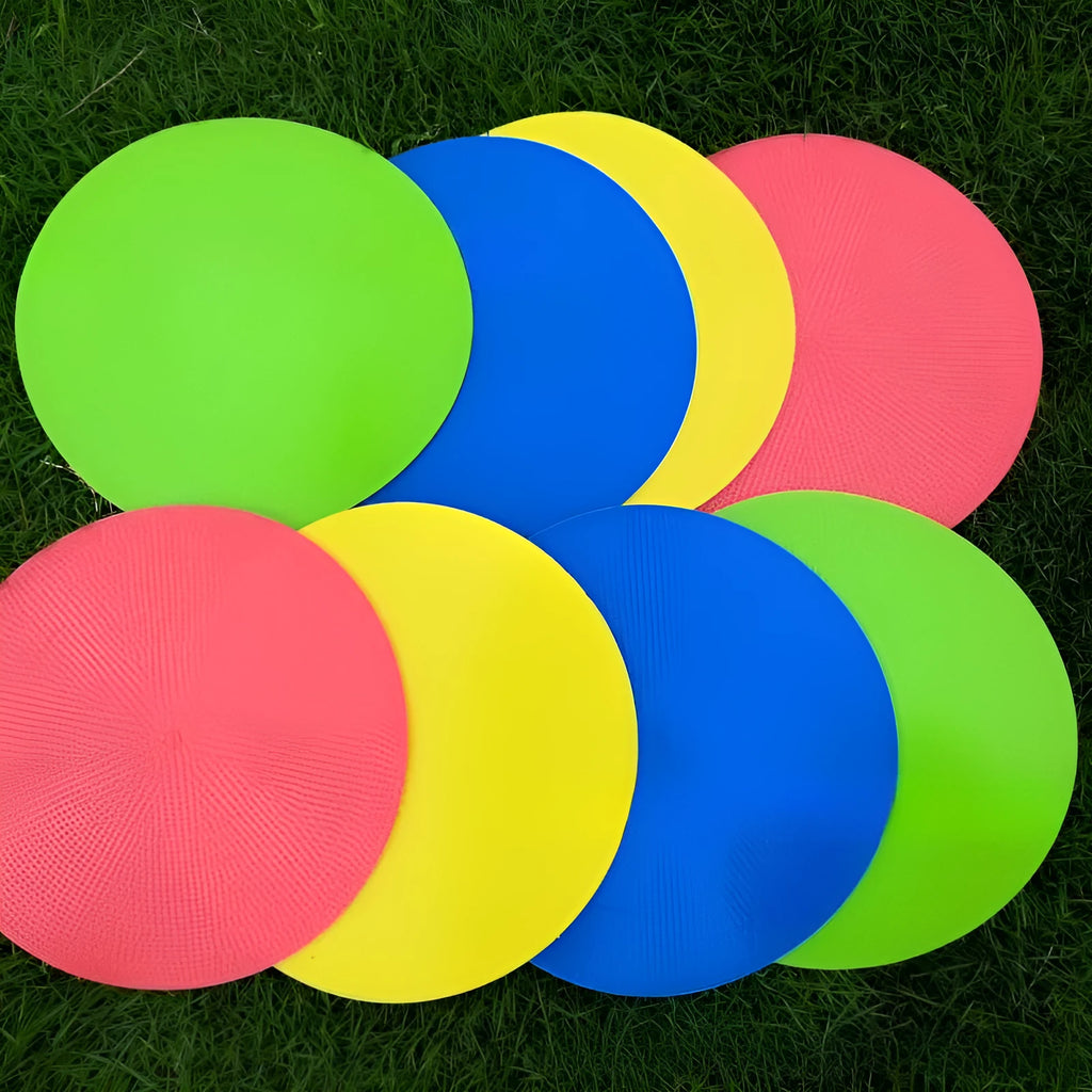 Flat yellow TPE football training landmark pad disc on grass, 23 cm in diameter.