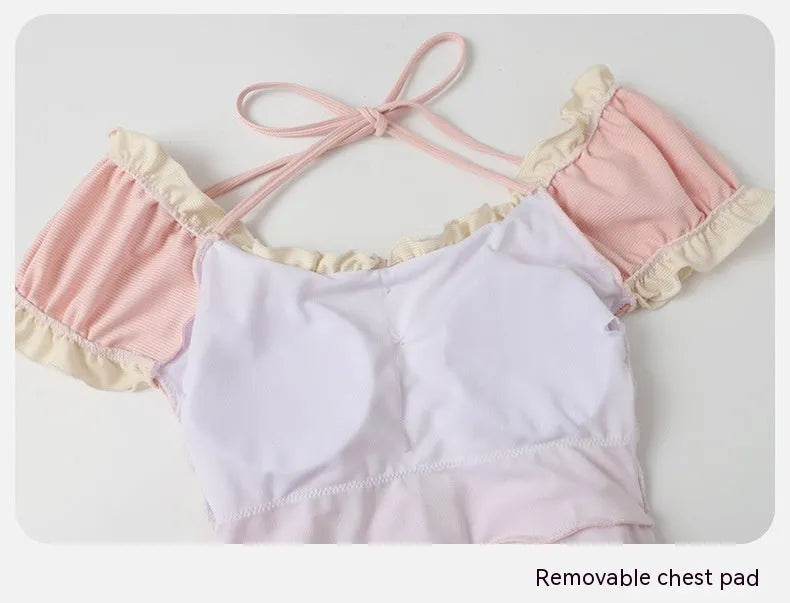 Women's pink conservative one-piece nylon swimsuit shown front view