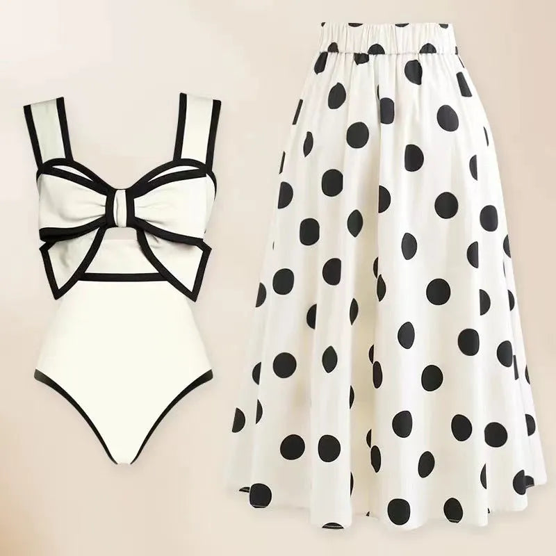 Women's black one-piece swimsuit with a white bow and round skirt, made from polyester.
