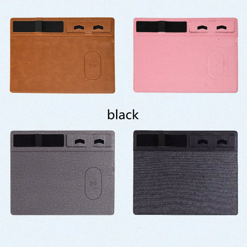 Pink wireless charging mouse pad with integrated phone holder on a wooden desk.