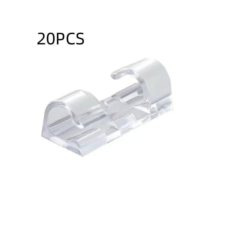 Transparent plastic self-adhesive cable management clips in four sizes on a white background.