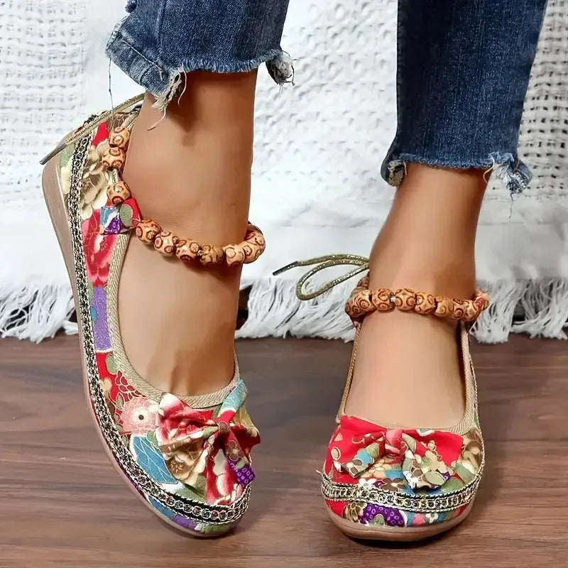 Women's black plus size ethnic platform sandals with cloth upper and elastic band.