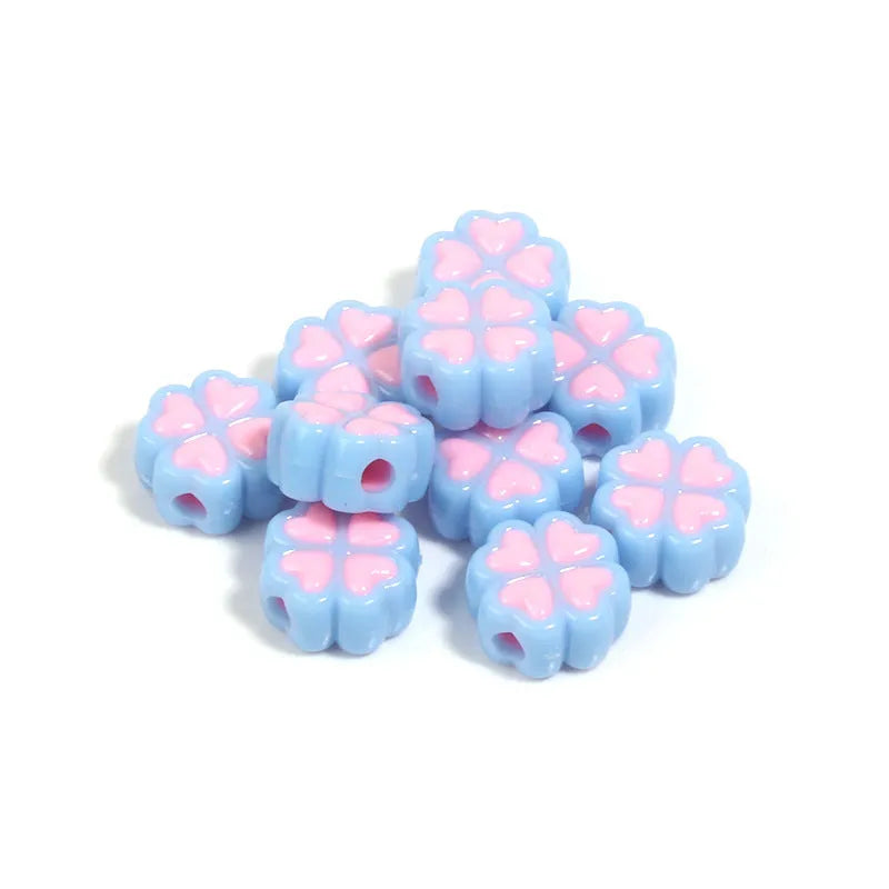Acrylic clover craft beads with frosted finish in mixed colours including pink, blue and green
