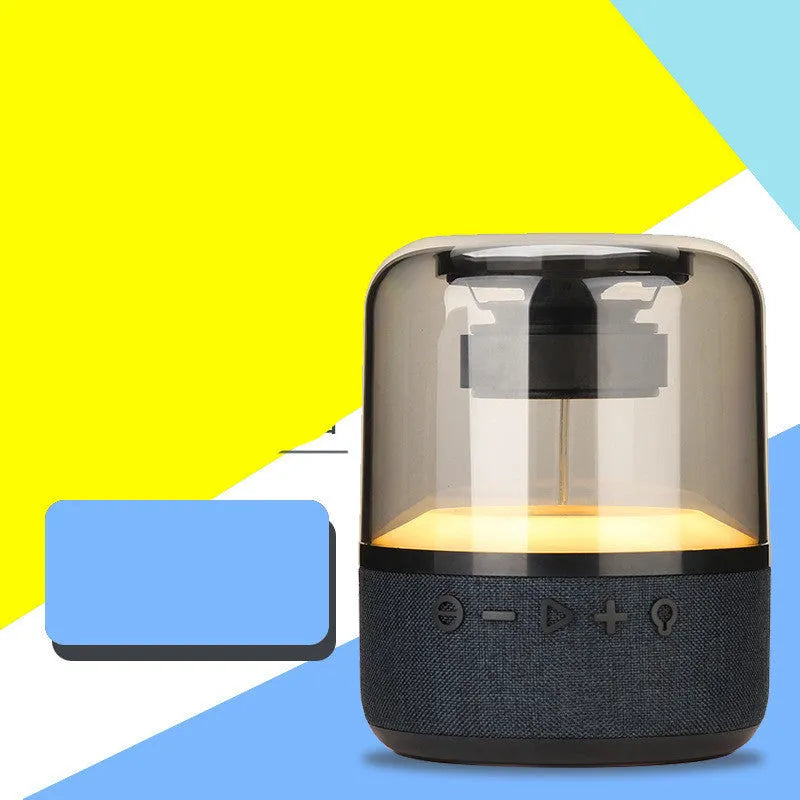 Black wireless Bluetooth speaker with LED lighting and touch controls showing four colours