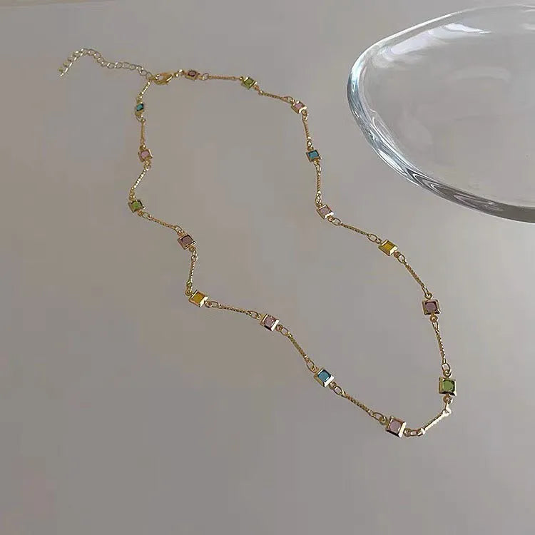 Square geometric clavicle chain necklace in gold or white K tone with alloy and artificial crystal.