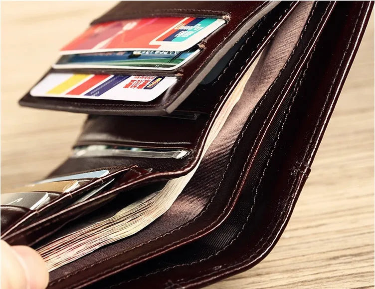 Men's black and coffee brown leather wallet open to show multiple internal card slots, note pocket, and coin compartment.