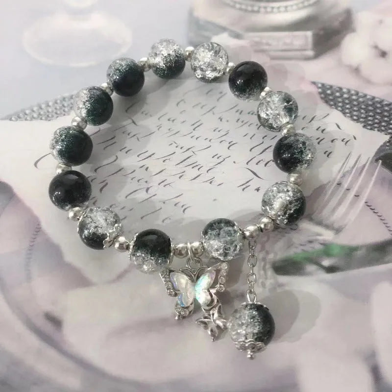 Chinese style handmade glass bead bracelet with bamboo joint elements on a white background.