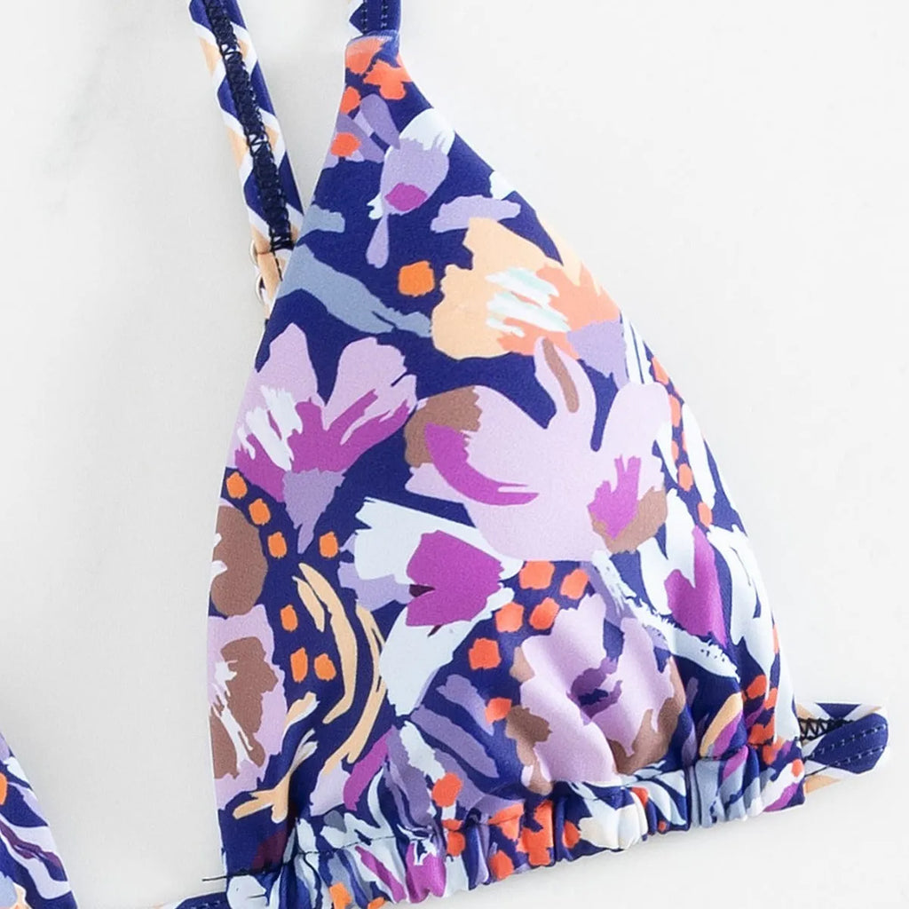 Women's floral print polyester swimsuit briefs on a white background.