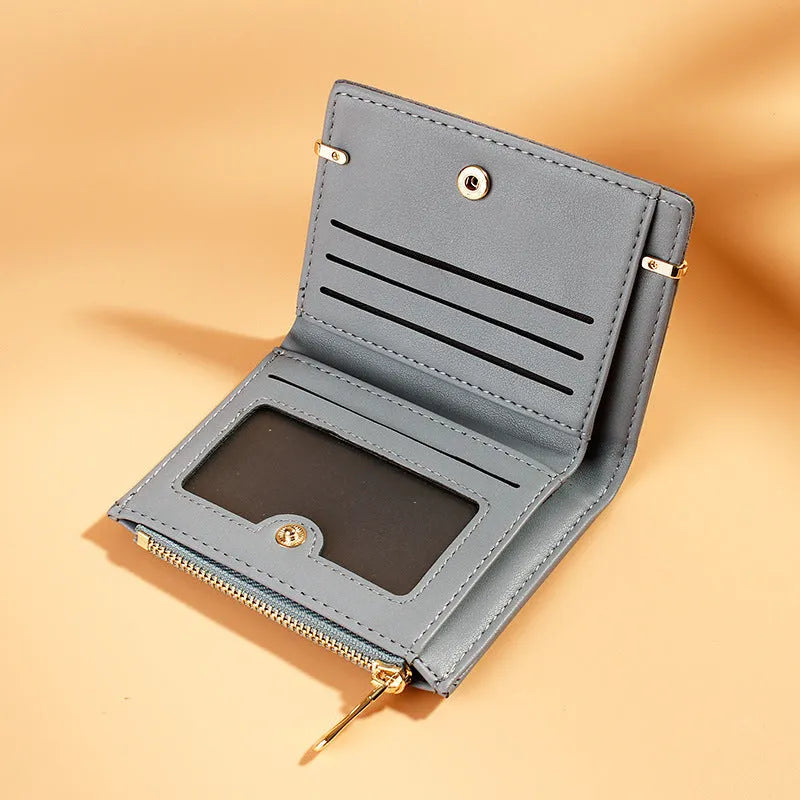 Short zipper ladies wallet in PU leather showing internal card slots, bill holder and change compartment.