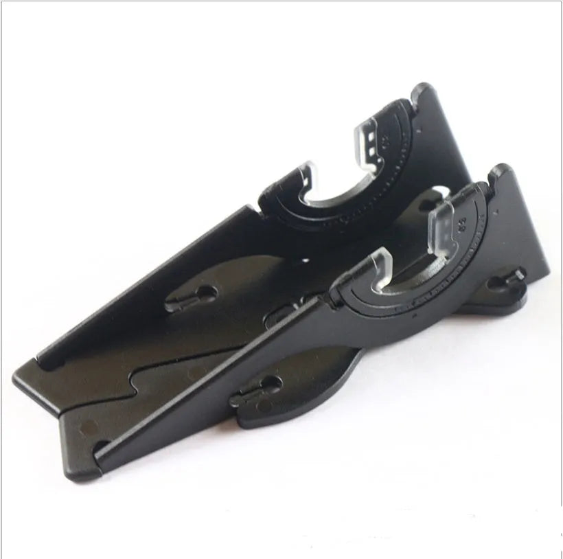 Black plastic card type mobile phone holder with lazy bracket on a desktop.