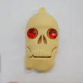 Halloween skeleton skull design USB flash drive with small chain on white background.