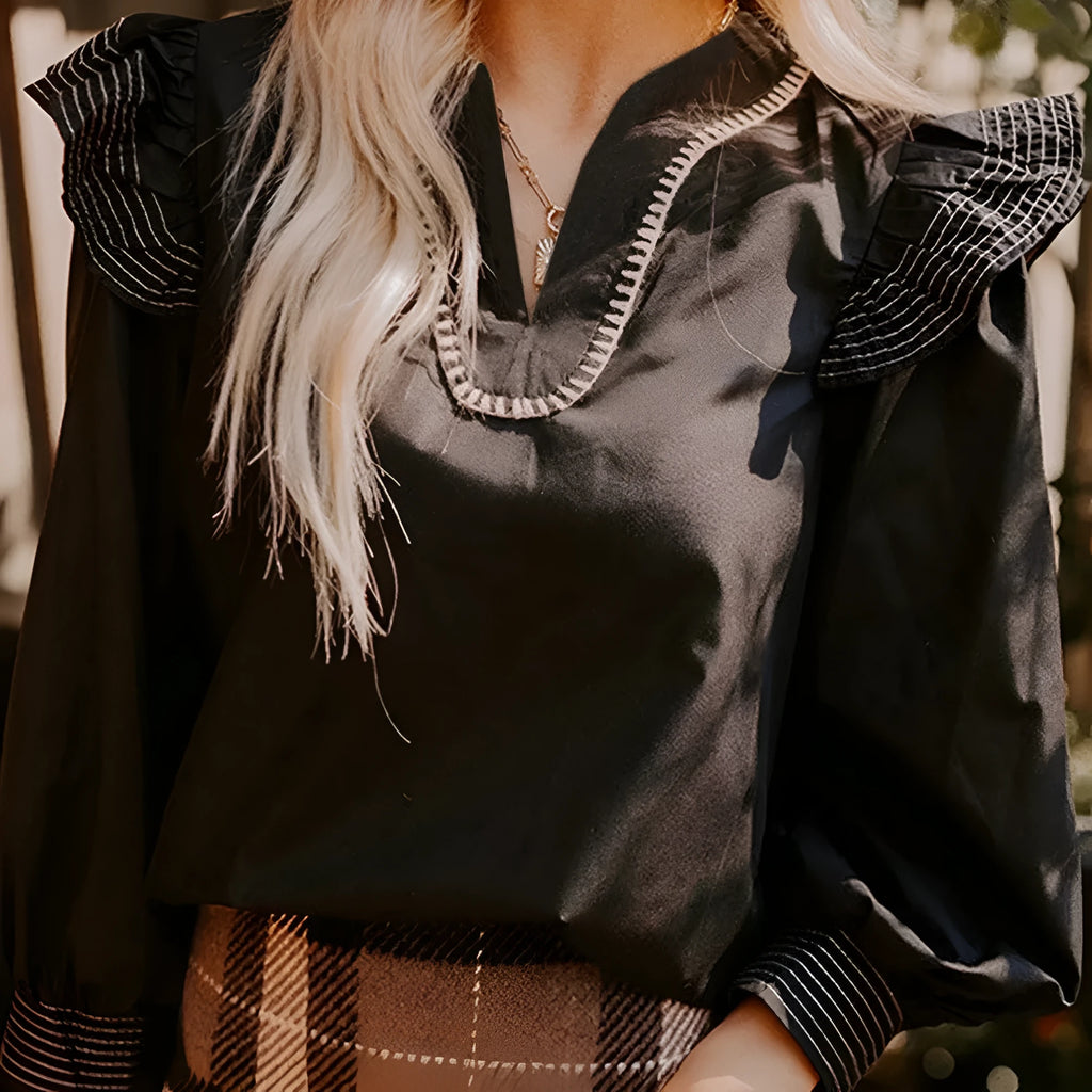 Black long sleeve blouse with V-neck, contrast stitching and ruffle sleeve detailing