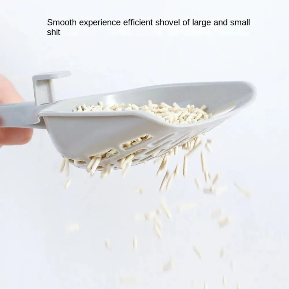 Grey plastic cat litter scoop with anti-slip handle sitting on its matching plastic base tray.