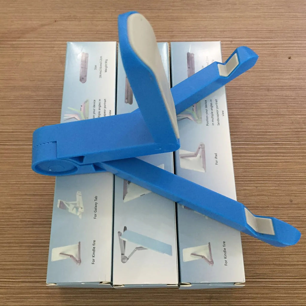 Black foldable tablet holder open on a desk supporting a tablet in landscape mode.