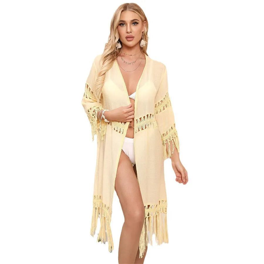 Hand-crocheted yellow beach cardigan cover-up with tassel detailing on mannequin