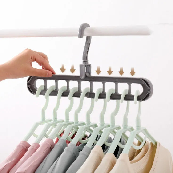 Plastic clothes hanger with a rotating hook in assorted colours on a white background.