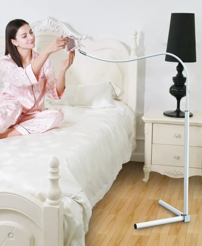Black mobile phone bed bracket with adjustable universal holder mounted on bed frame