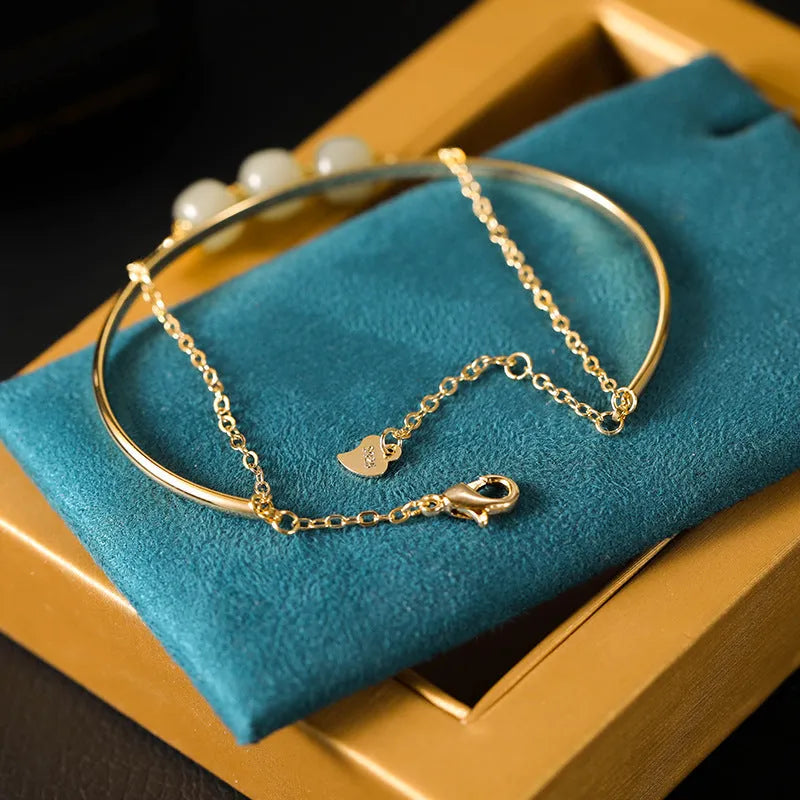 Hetian jade lucky beads bracelet for women with gold inlay, shown in single, double and three bead versions.