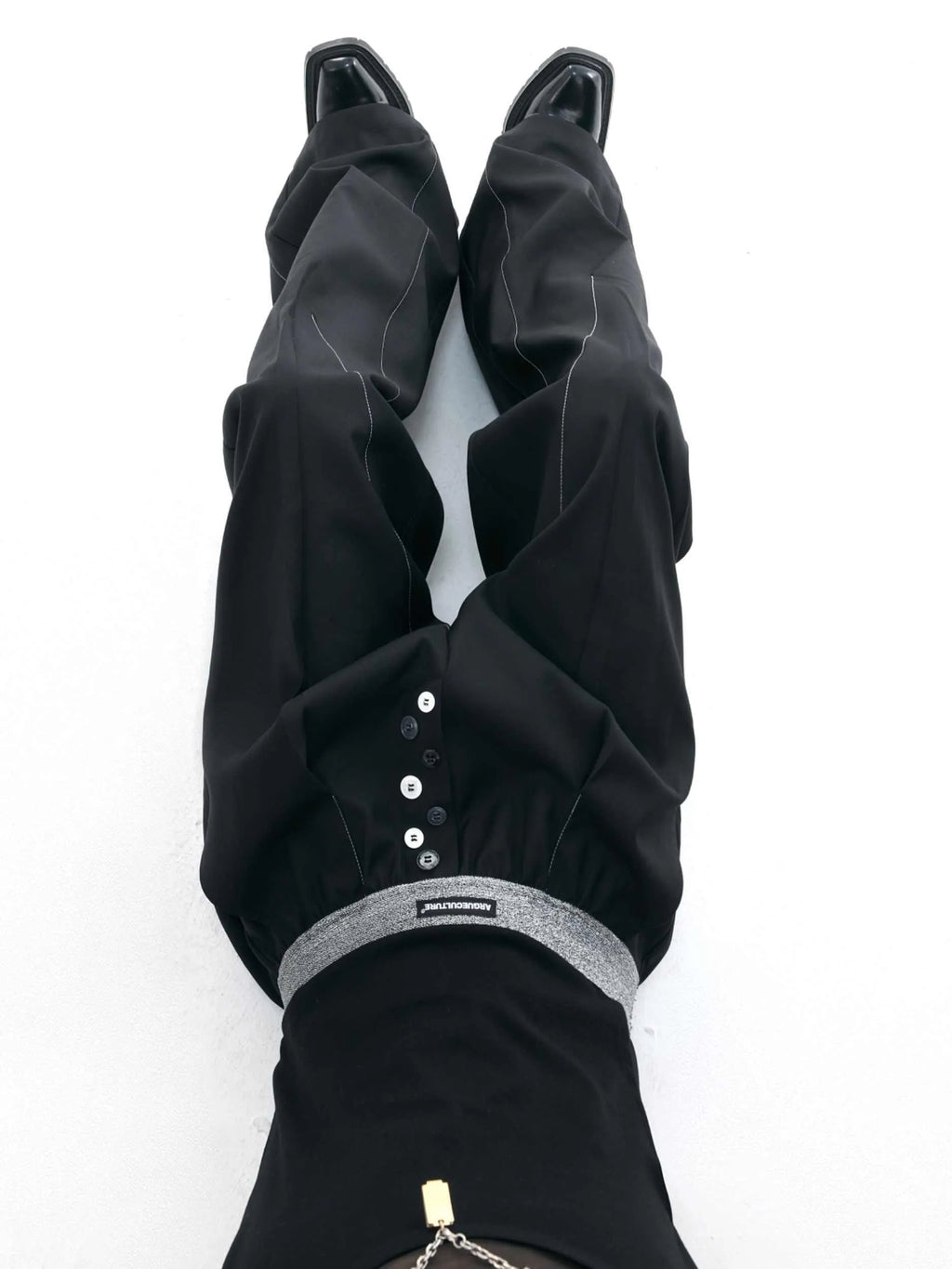 Drooping straight-leg casual trousers with button open line detail in black or grey colours