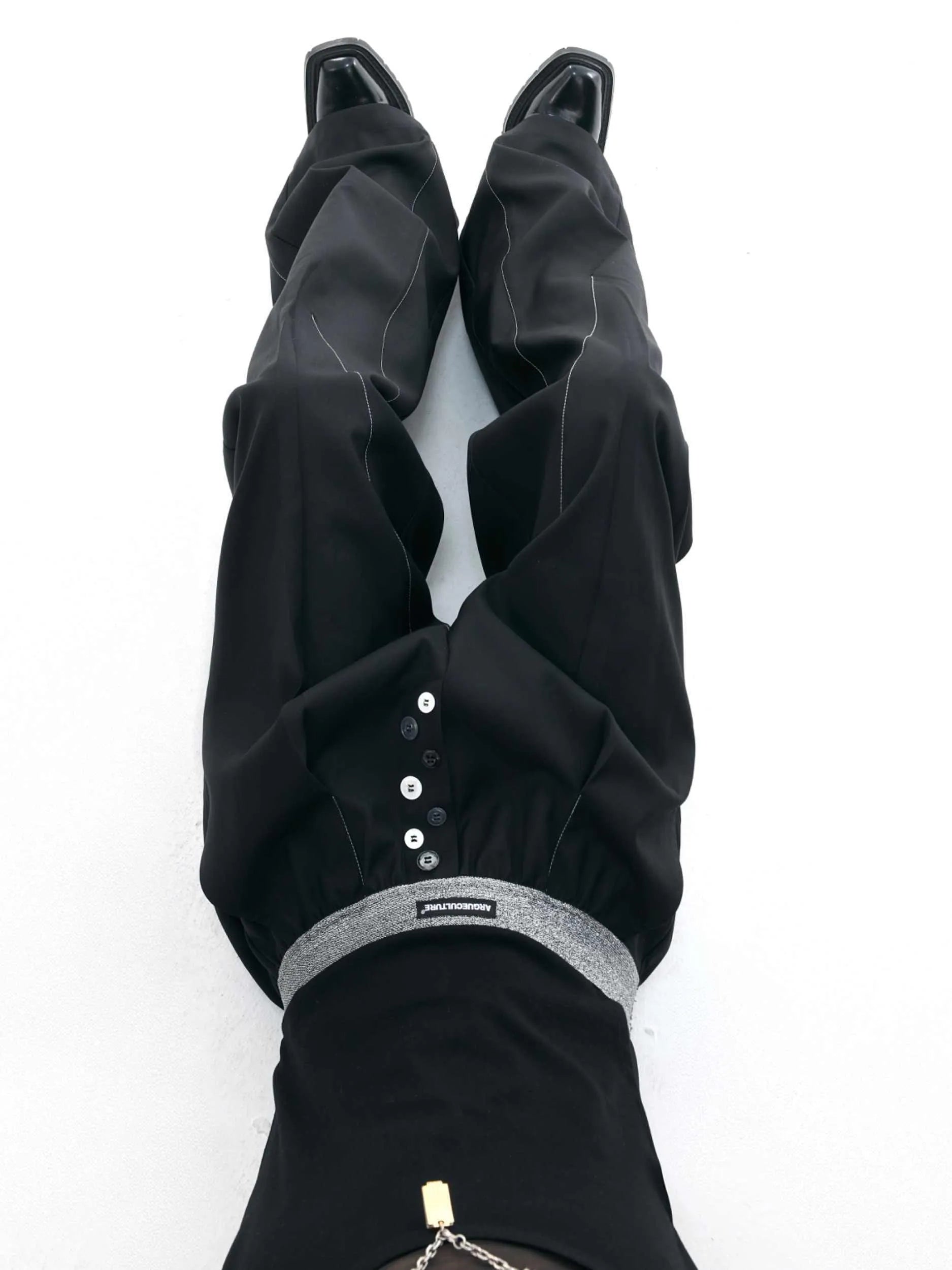 Drooping straight-leg casual trousers with button open line detail in black or grey colours