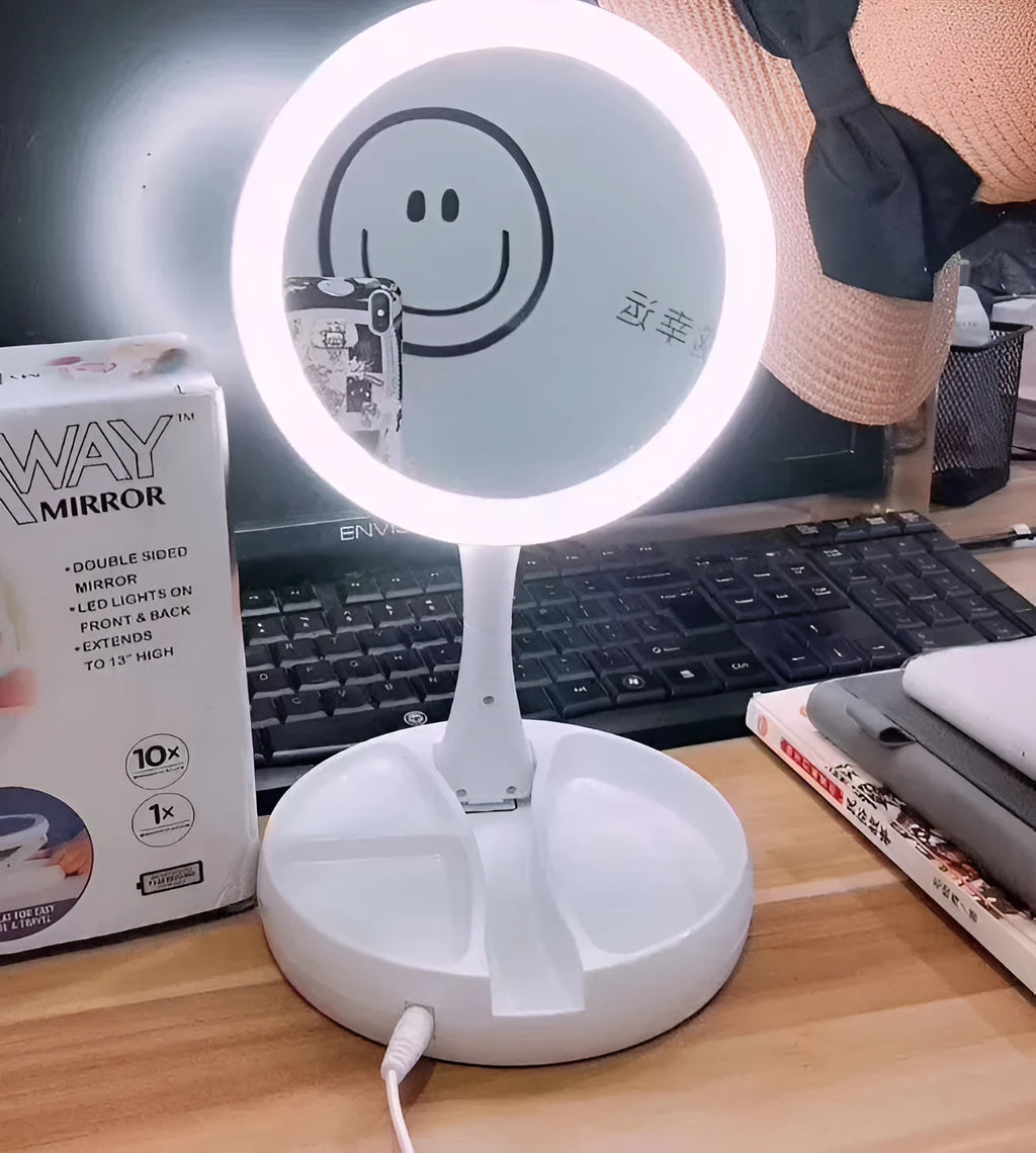 White foldable LED vanity mirror with storage tray and USB cable.