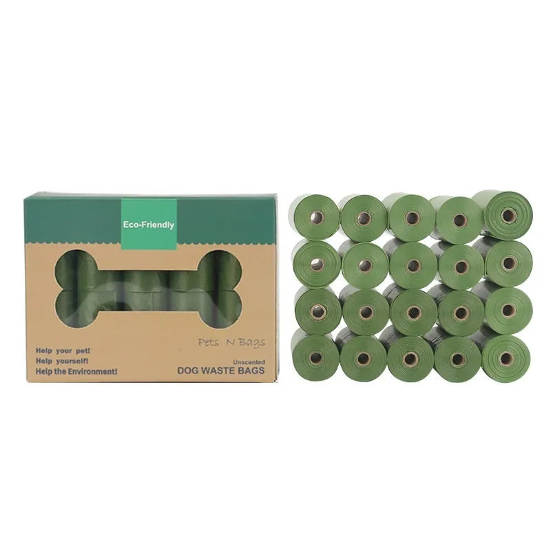 Roll of green EPI degradable dog poop bags next to a white dispenser on a table.
