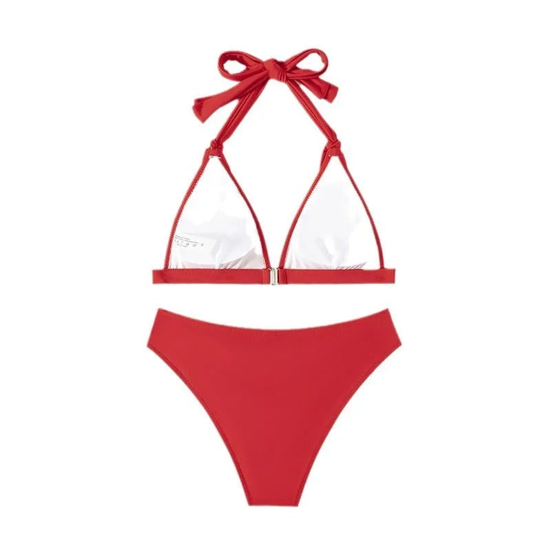 Red women's lace-up halterneck bikini set with matching split beach shorts.