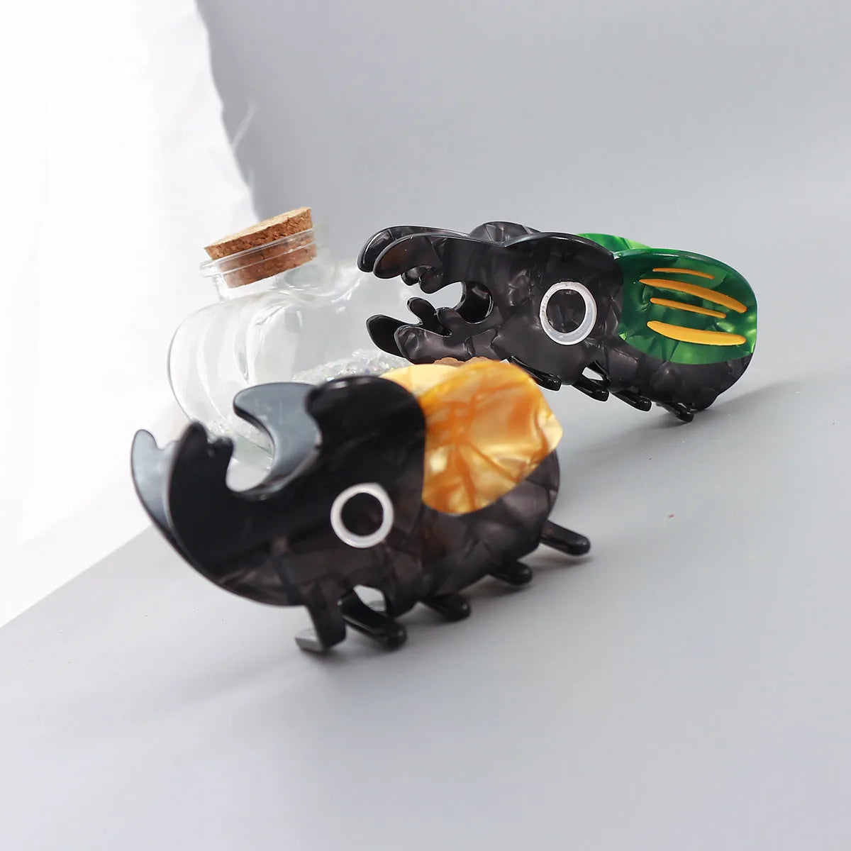Cellulose acetate insect grip sheet with handmade beetle or caterpillar cartoon design