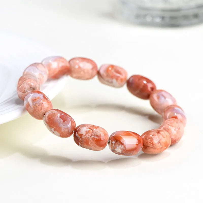 Natural cherry agate bracelet with geometric barrel beads and a Ruyi design detail.