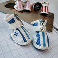 Set of four blue zipper closure cloth dog shoes with non-slip soles for small pets.