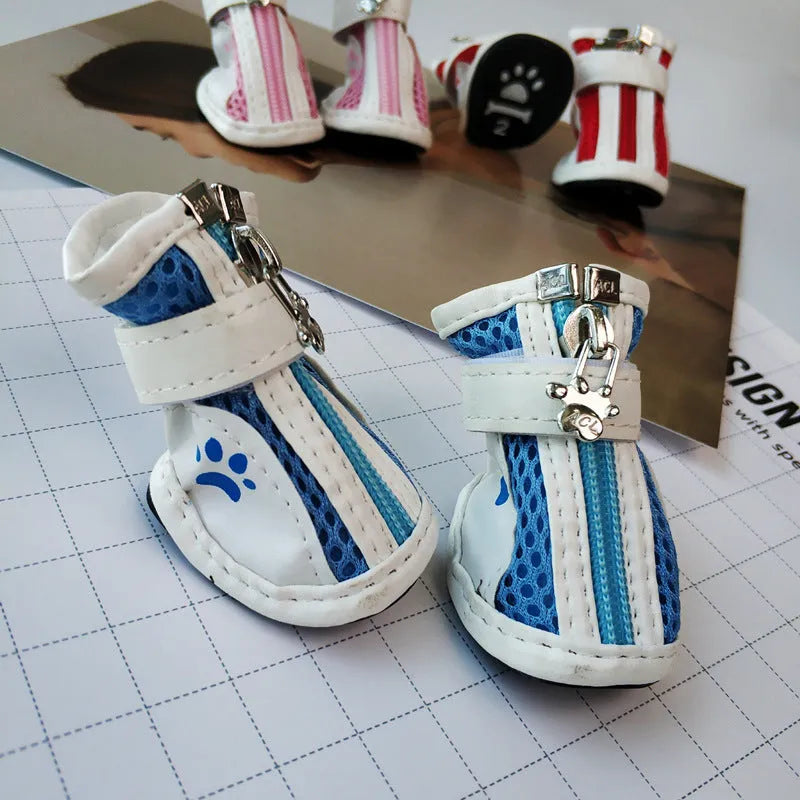 Set of four blue zipper closure cloth dog shoes with non-slip soles for small pets.