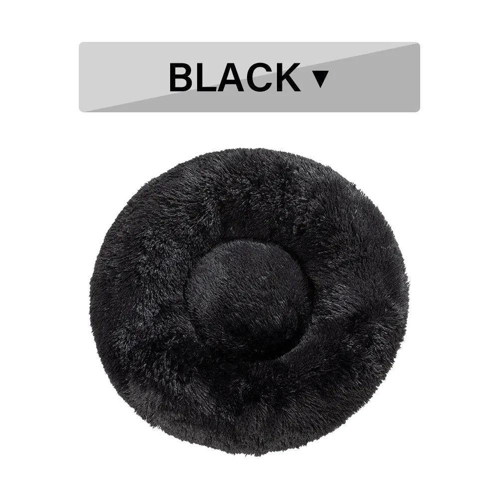 A round donut-shaped dog bed with a raised plush rim, shown in a light grey colour.