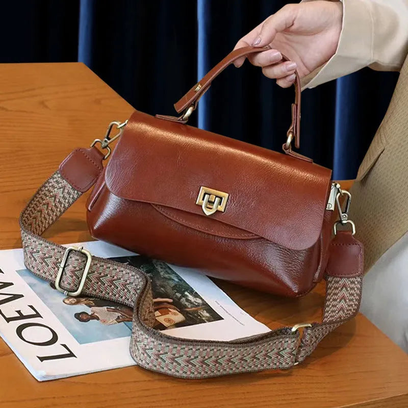 Women's brown leather saddle handbag with open outer pocket and double shoulder straps
