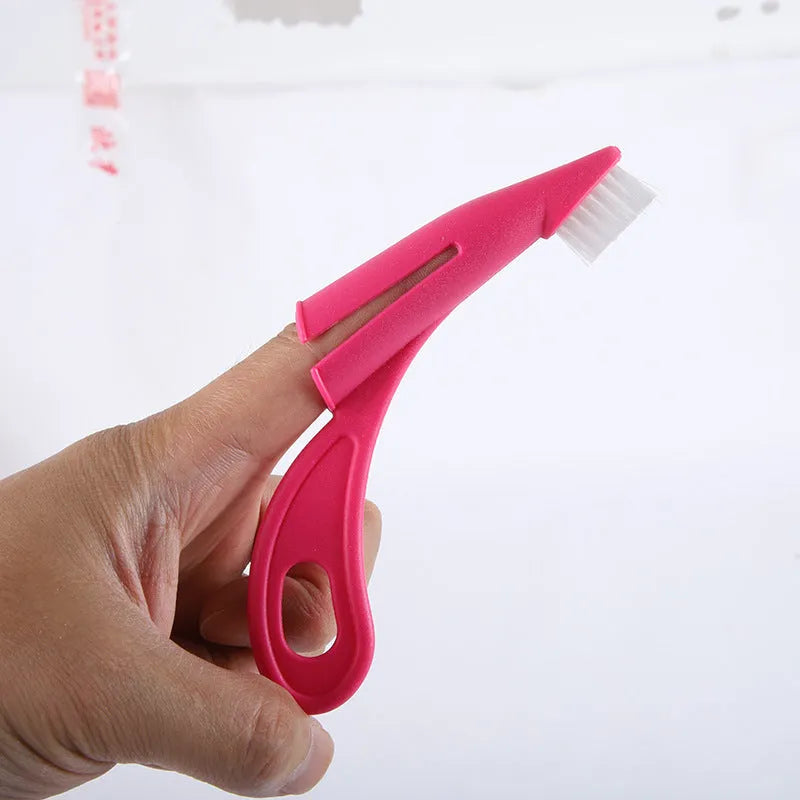 Red and white finger-sleeve toothbrush for pet dental cleaning with soft silicone bristles.