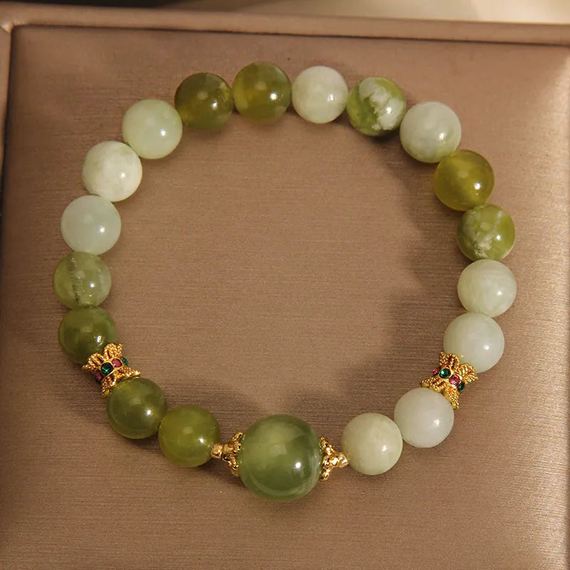 Xiuyan jade green women's bracelet with original design on a wrist.