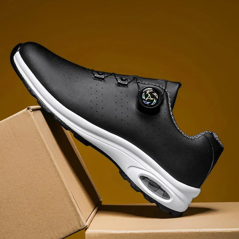 Low-top black and white casual tennis shoes with mesh upper and flat composite sole.