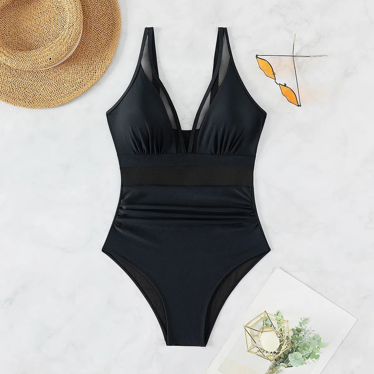 Black women's one-piece swimsuit with mesh halter neck and briefs style bottom.