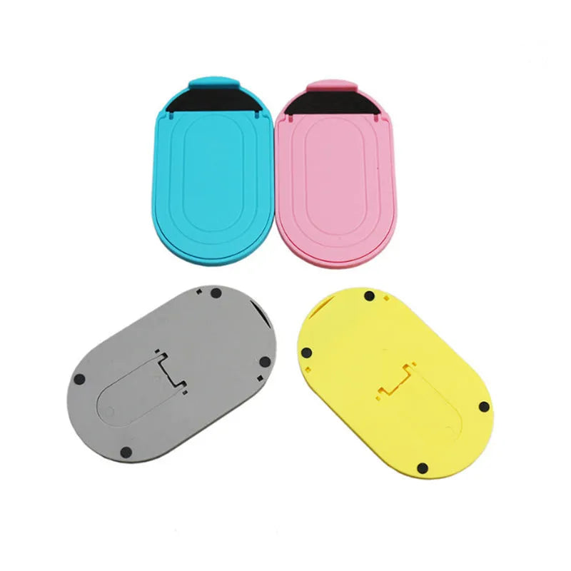 Plastic mobile phone stand with lazy bracket, holding a smartphone, shown in multiple colour options.
