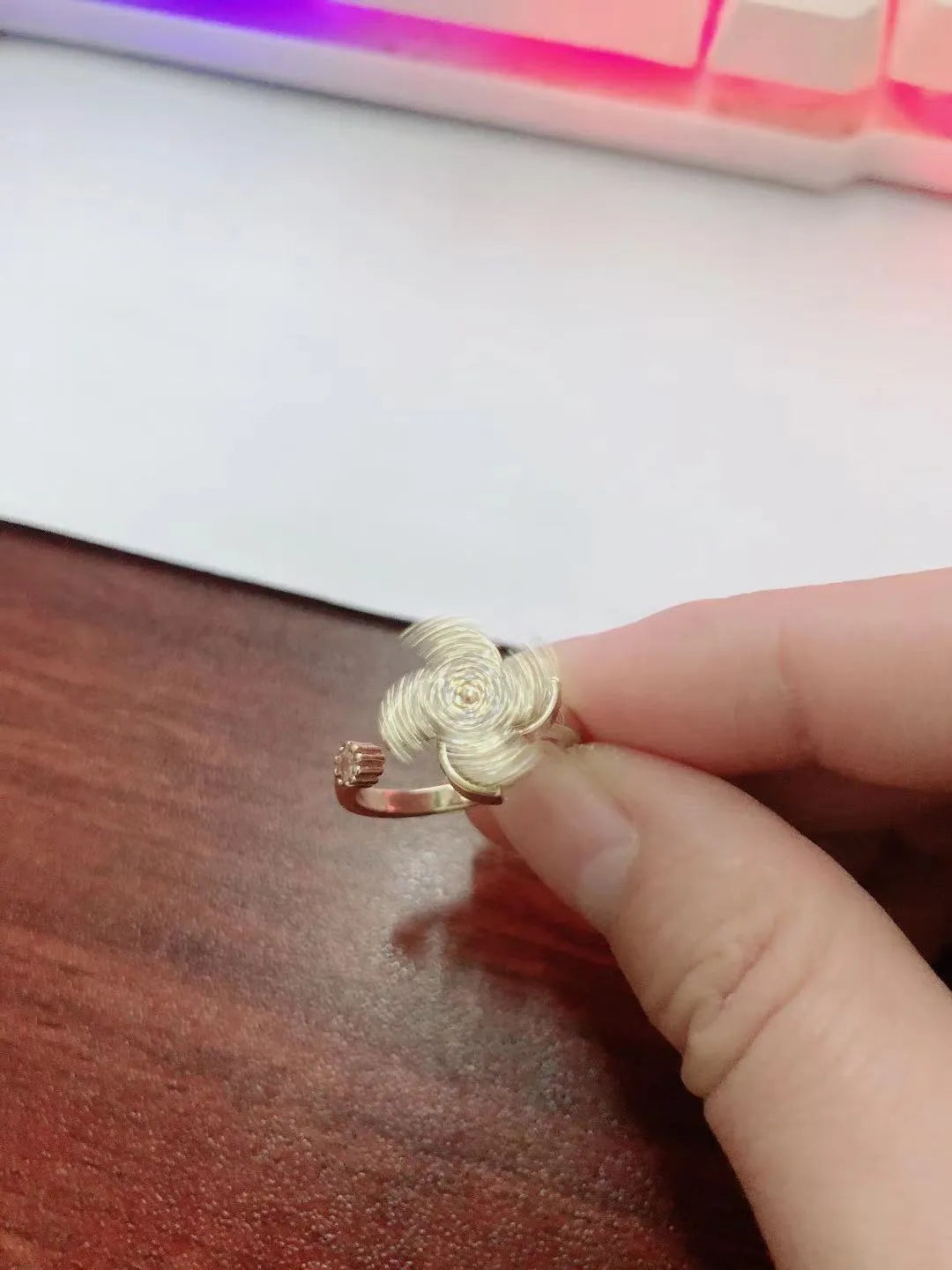 Copper rotating ring with a spinning windmill centre in gold or silver electroplated finish.