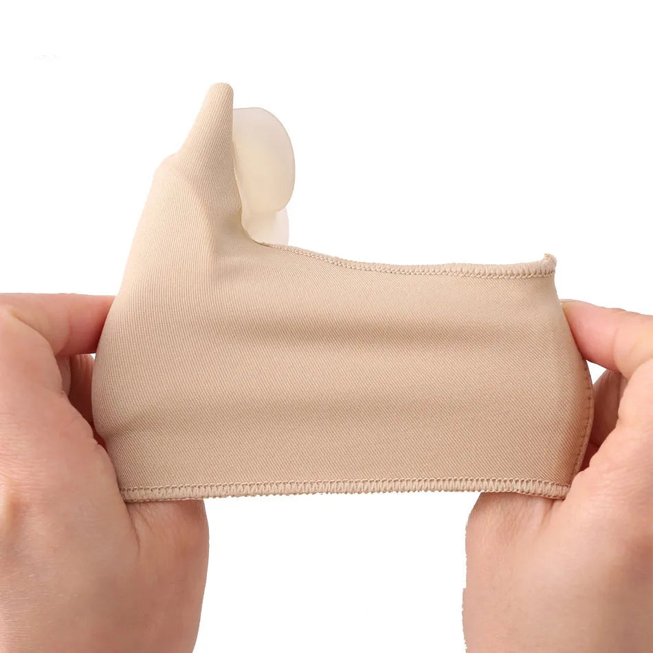 Corrective bunion relief sock with gel pad and silicone toe separator on a foot.