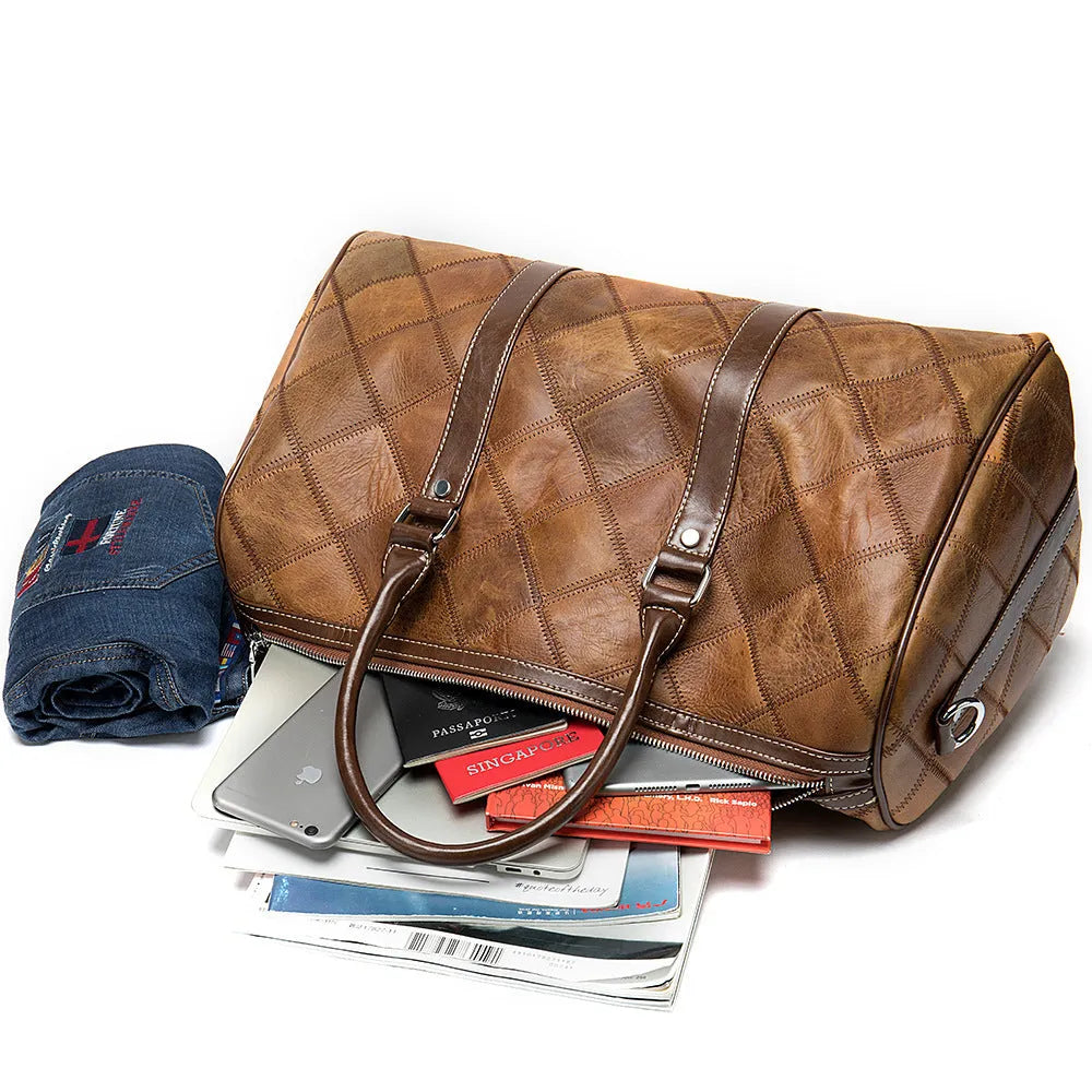Vintage brown cowhide leather men's duffel bag with a single shoulder strap, shown open to reveal internal organiser pockets.