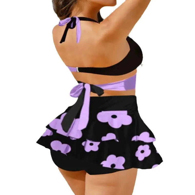 Women's purple bikini swimsuit with matching skirt featuring high waist briefs and lace-up design