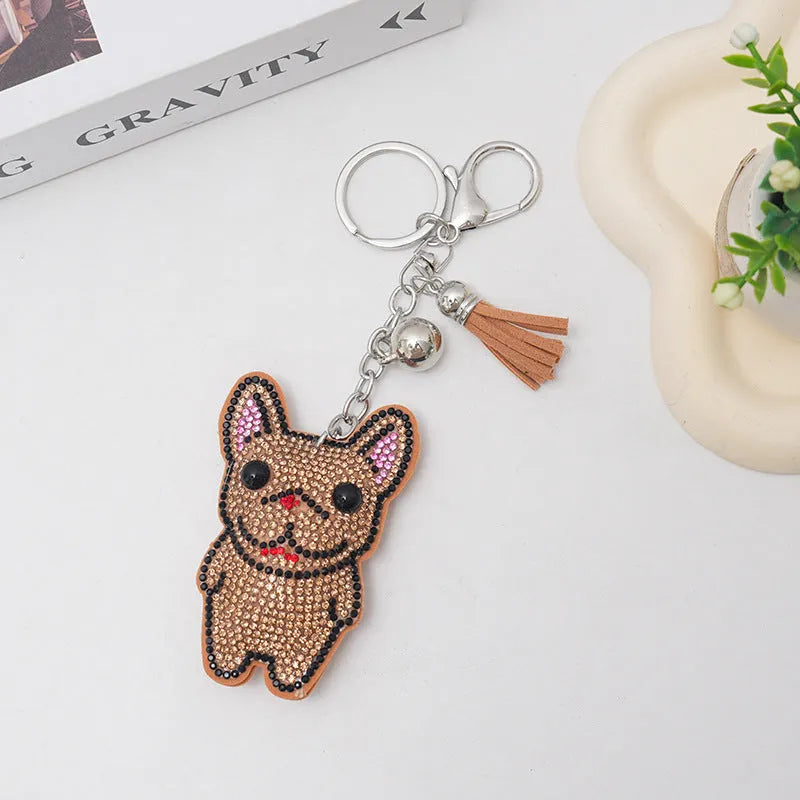 Close-up of a cartoon dog rhinestone keychain pendant on an alloy keyring