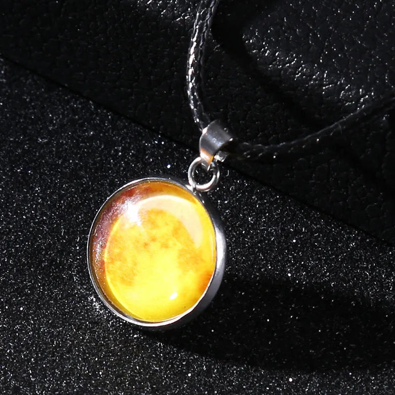 Luminous moon and constellation pendant necklace on a chain with an extension, shown in one of ten possible colours.